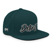 Black & White Detroit Embroidery  Spruce / Evergreen Colorway  Bakslash Embroidery in White on Back  This hat is structured with a classic fit, flat brim, and full buckram. The adjustable snap closure makes it a comfortable, one-size-fits-most hat.